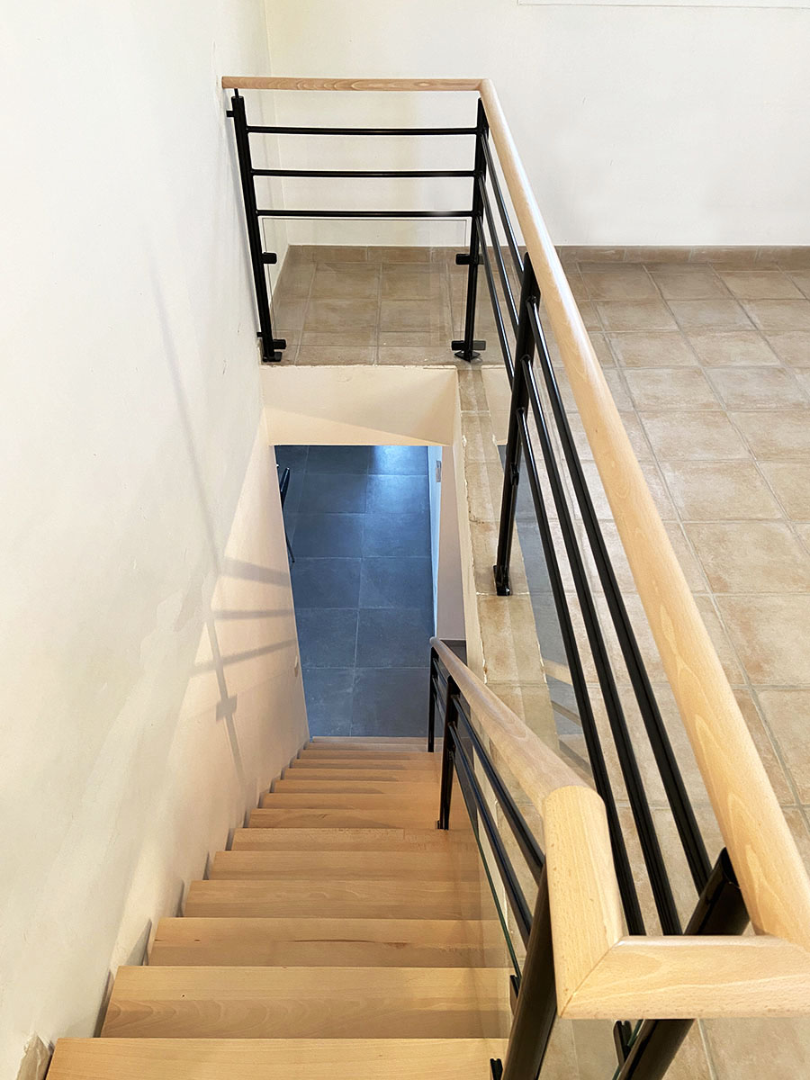 Marches et main courante — Hêtre.
Finition — Verni incolore.
Limon — Métal thermolaqué.
Garde corps — Verre et métal thermolaqué.